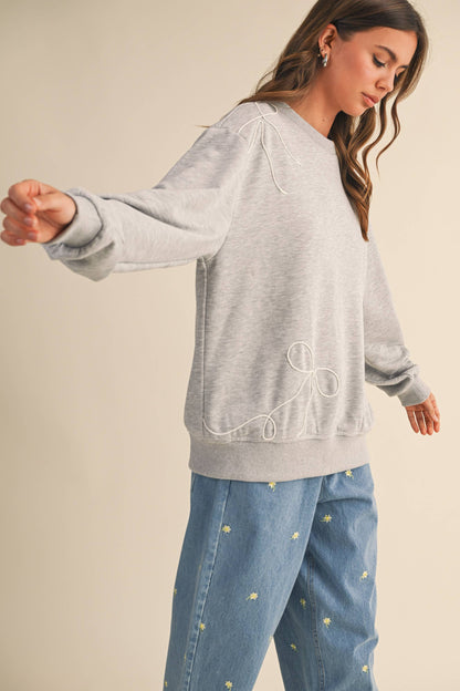 BOW APPLIQUÉ SWEATSHIRT