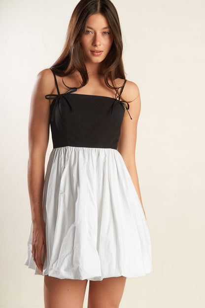 A solid knit woven combination mini dress