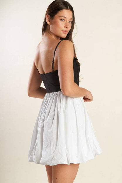 A solid knit woven combination mini dress