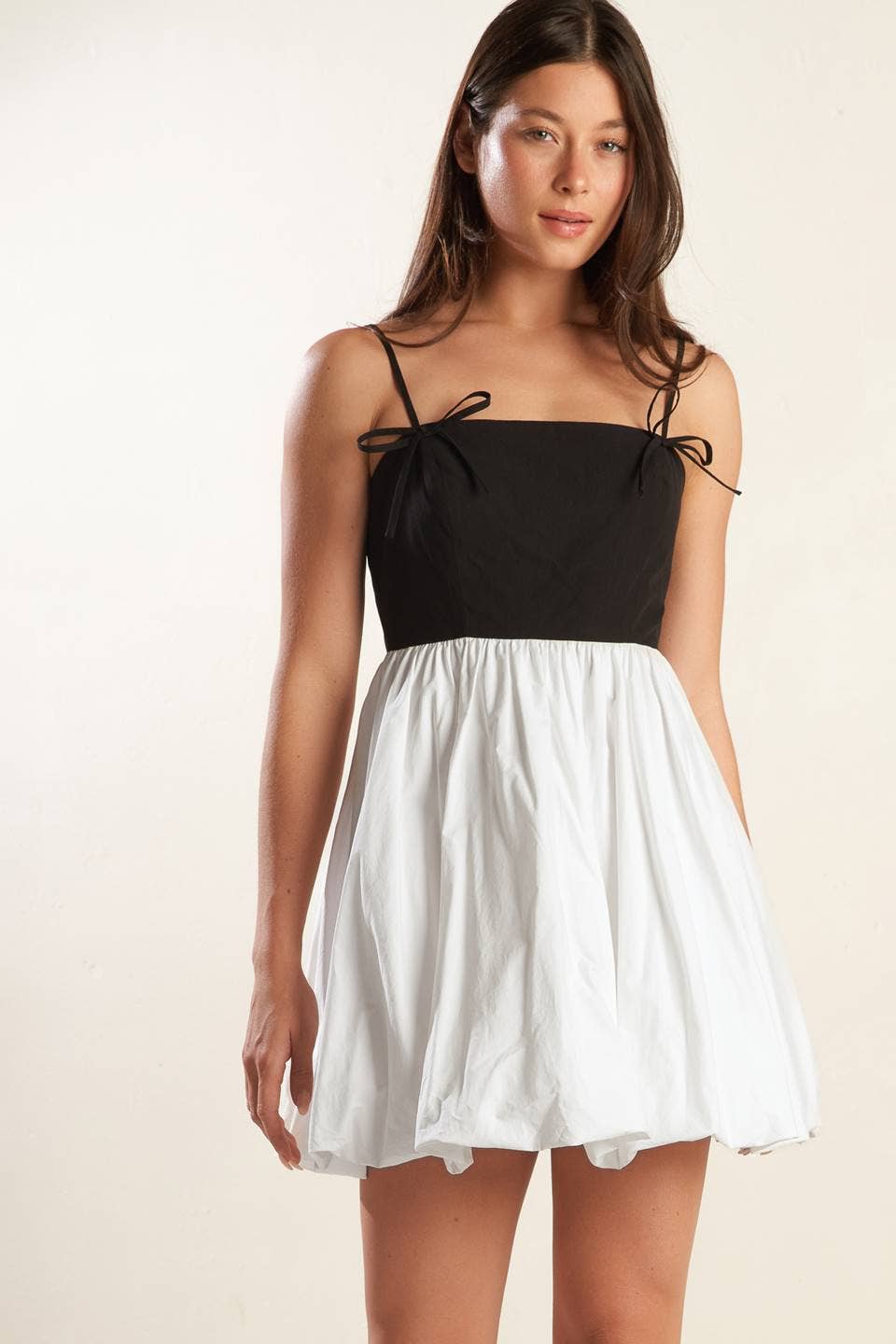 A solid knit woven combination mini dress