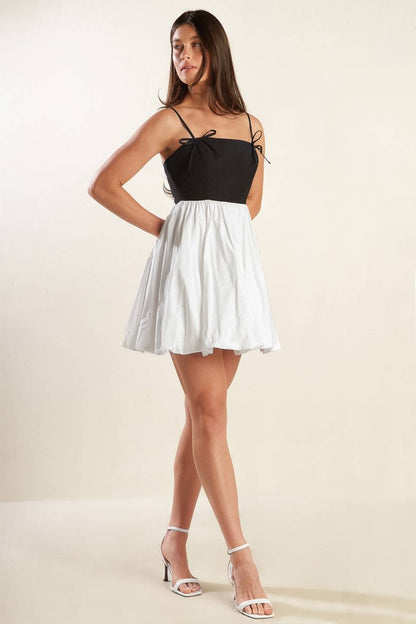 A solid knit woven combination mini dress