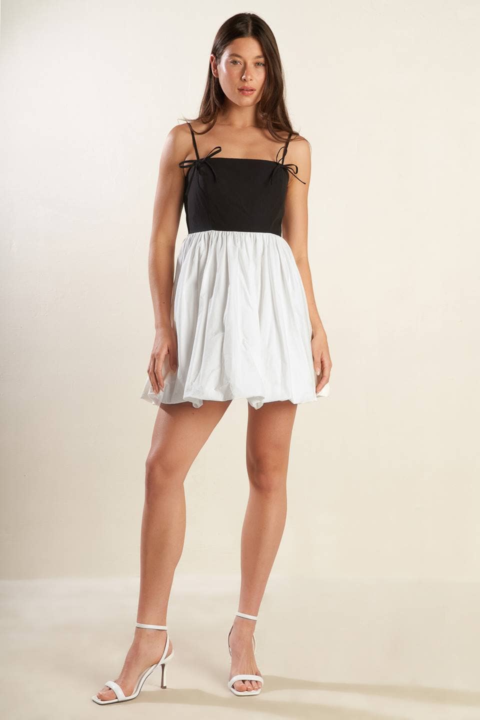 A solid knit woven combination mini dress